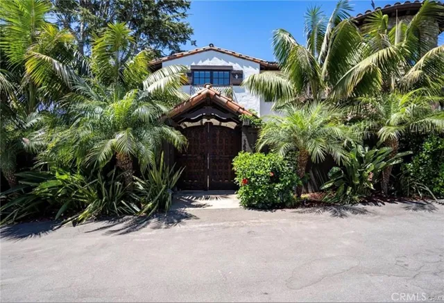 a backyard of a house with barbeque oven table and chairs