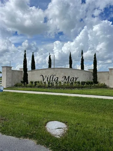 a view of a garden with a building in the background