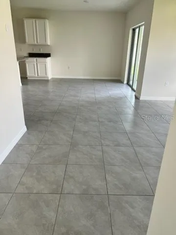 a view of hallway with stairs and a window