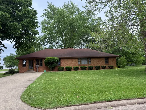 a view of a house with a backyard and a patio
