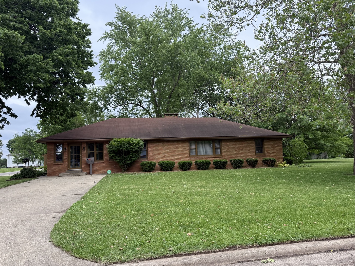 a view of a house with a backyard and a patio