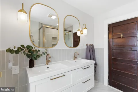 a bathroom with a double vanity sink and a mirror