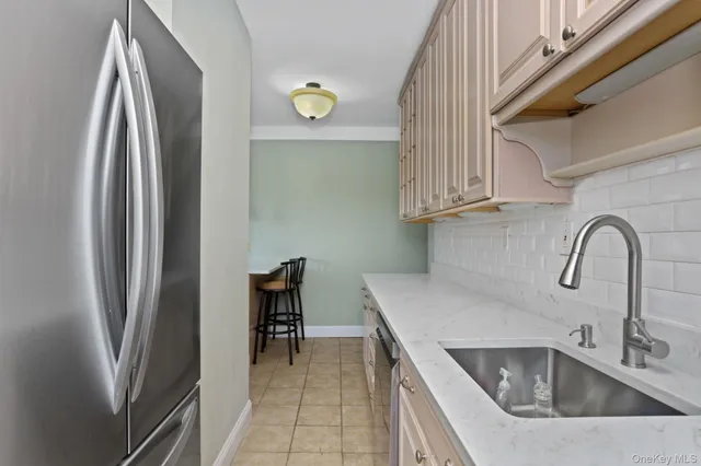 a kitchen with stainless steel appliances granite countertop a sink and a refrigerator