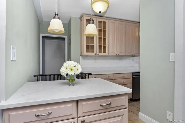 a kitchen with a sink and a chandelier