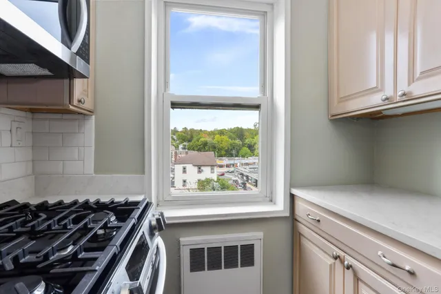 a kitchen with a stove and a window