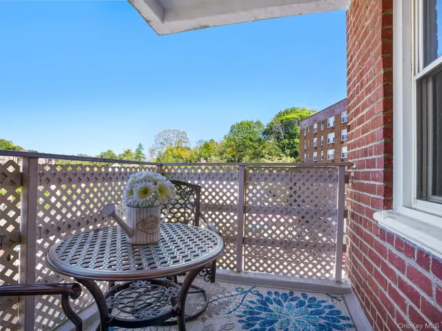 a view of a balcony with table and chairs