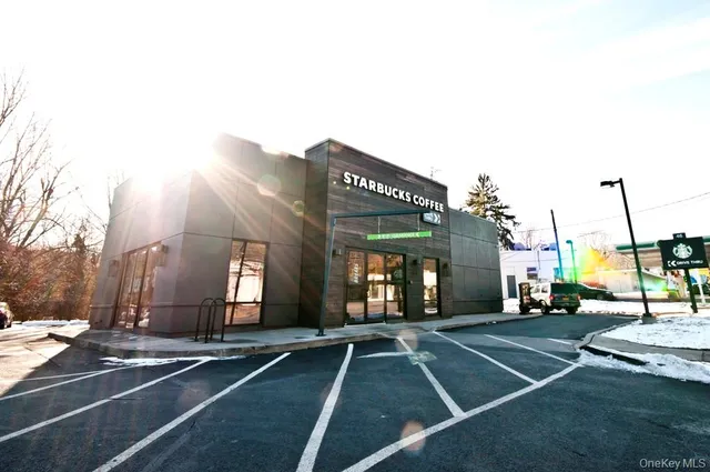 a picture of a bench in front of a white house