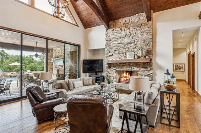 a large white kitchen with kitchen island a large island a sink a stove and cabinets