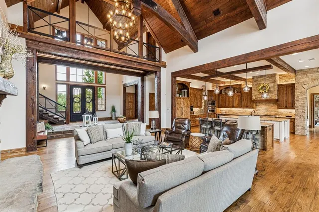 a kitchen with granite countertop lots of white cabinets and wooden floor
