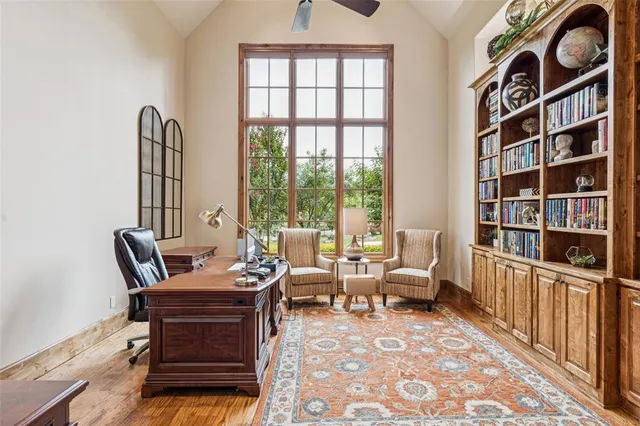 a bedroom with furniture and large windows
