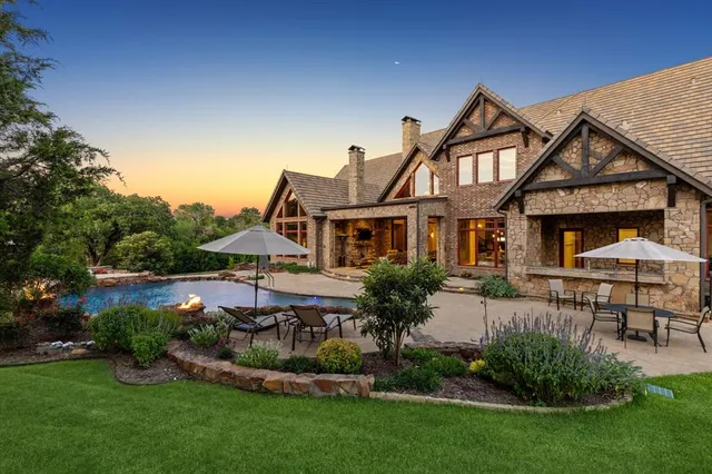 a front view of a house with a garden and plants