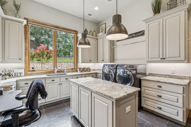 a bedroom with a bed chandelier and a window