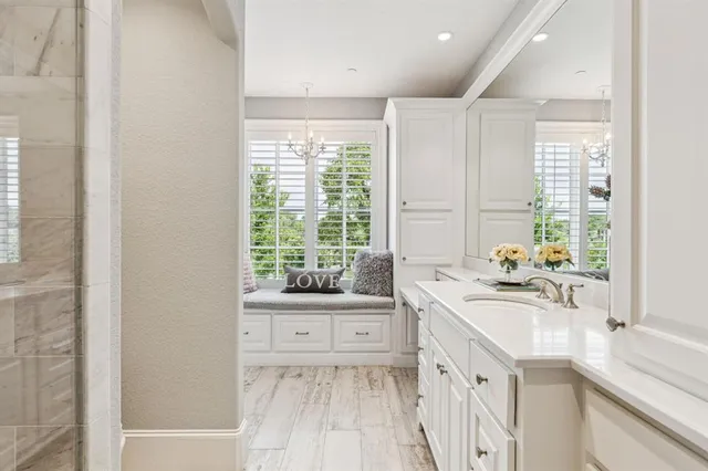 a bedroom with a bed and a table in it with wooden floor