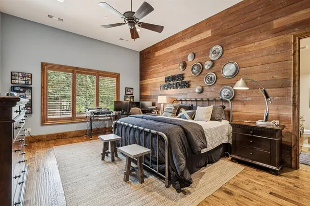 a view of swimming pool with outdoor seating and trees in the background