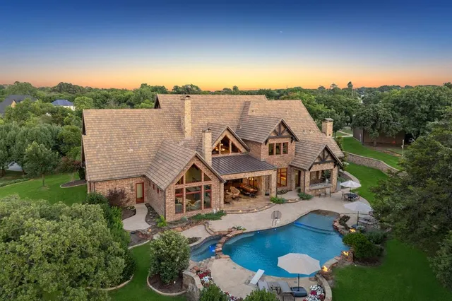 an aerial view of a house with garden space trees