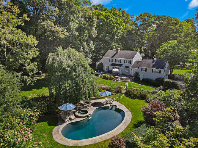 51 Logan Road New Canaan, CT 06840 - Photo 2 of 39 an aerial view of a house with swimming pool and garden