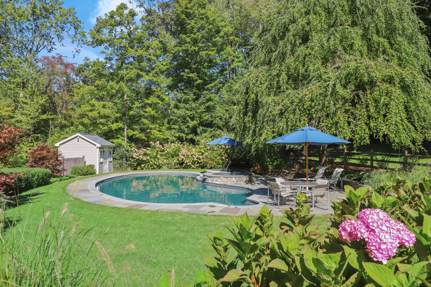 51 Logan Road New Canaan, CT 06840 - Photo 34 of 39 a backyard of a house with table and chairs