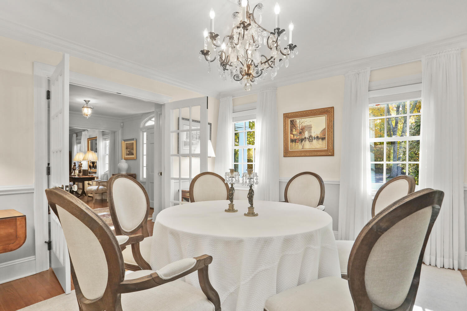 51 Logan Road New Canaan, CT 06840 - Photo 8 of 39 a dining room with chandelier fan and wooden floor