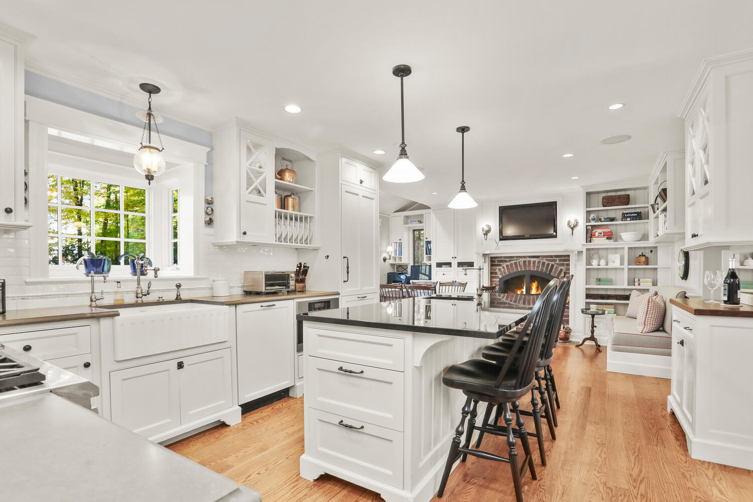 51 Logan Road New Canaan, CT 06840 - Photo 10 of 39 a kitchen with white cabinets and sink
