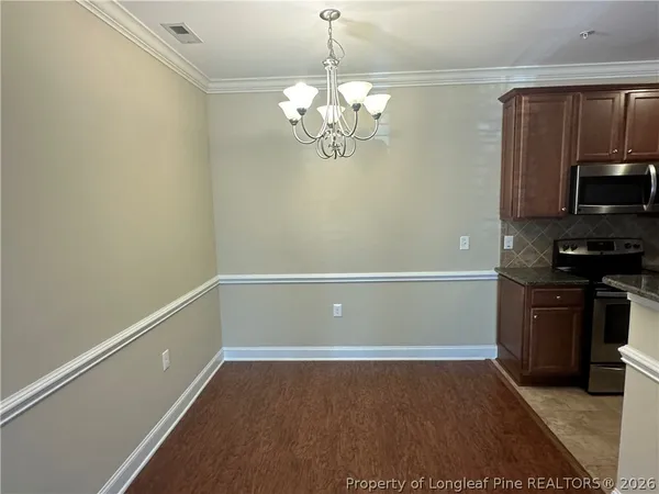 a view of a kitchen with a dishwasher cabinets and a wooden floor