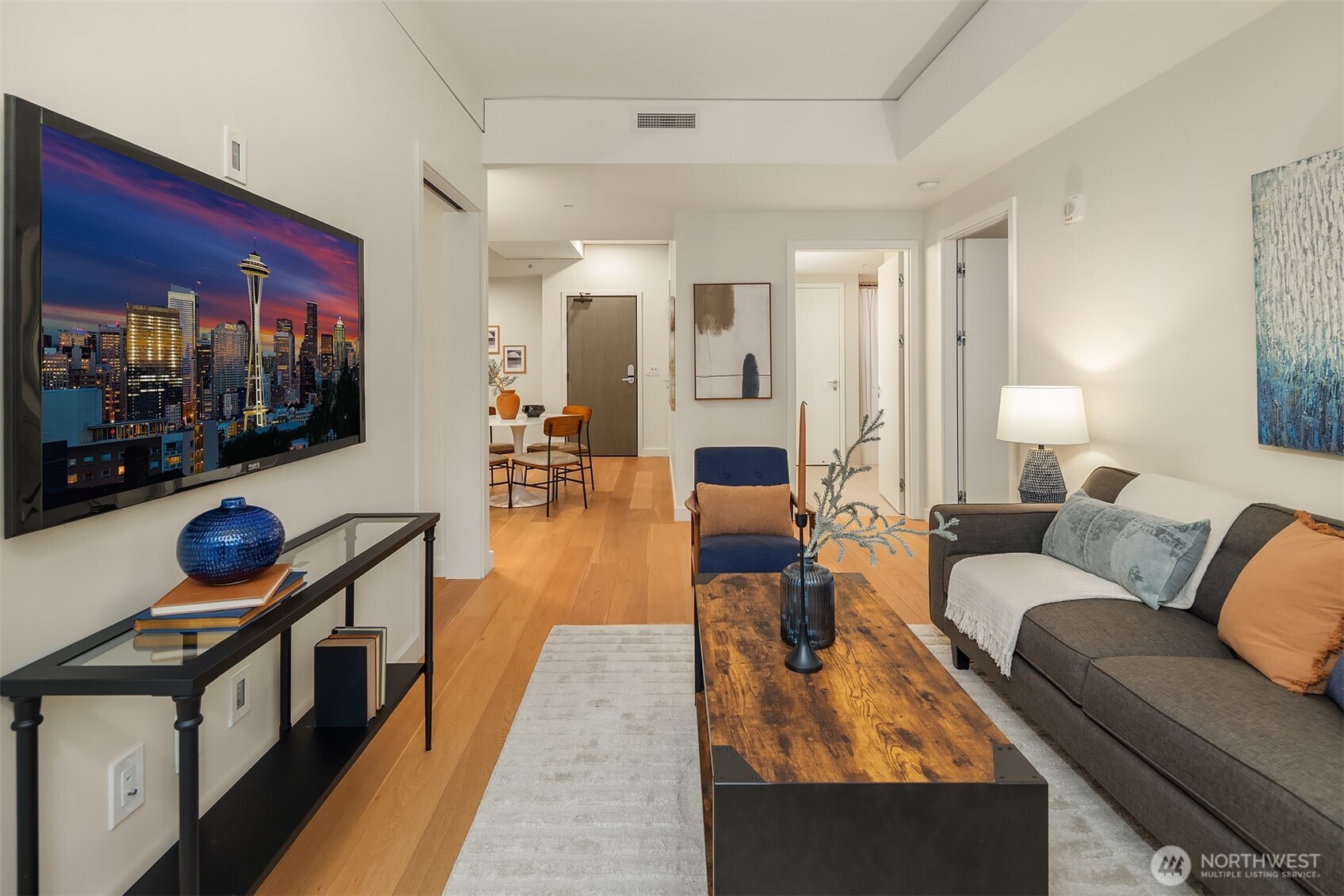 121 Stewart Street, Unit 1803 Seattle, WA 98101 - Photo 15 of 35 a living room with furniture and a flat screen tv