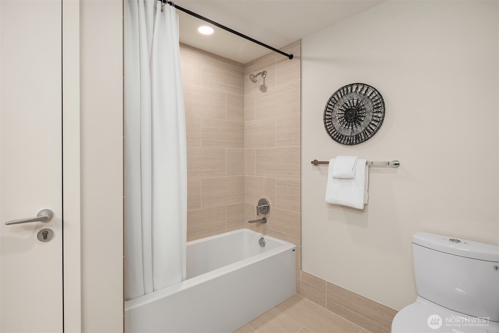 121 Stewart Street, Unit 1803 Seattle, WA 98101 - Photo 20 of 35 a bathroom with a bath tub and a shower