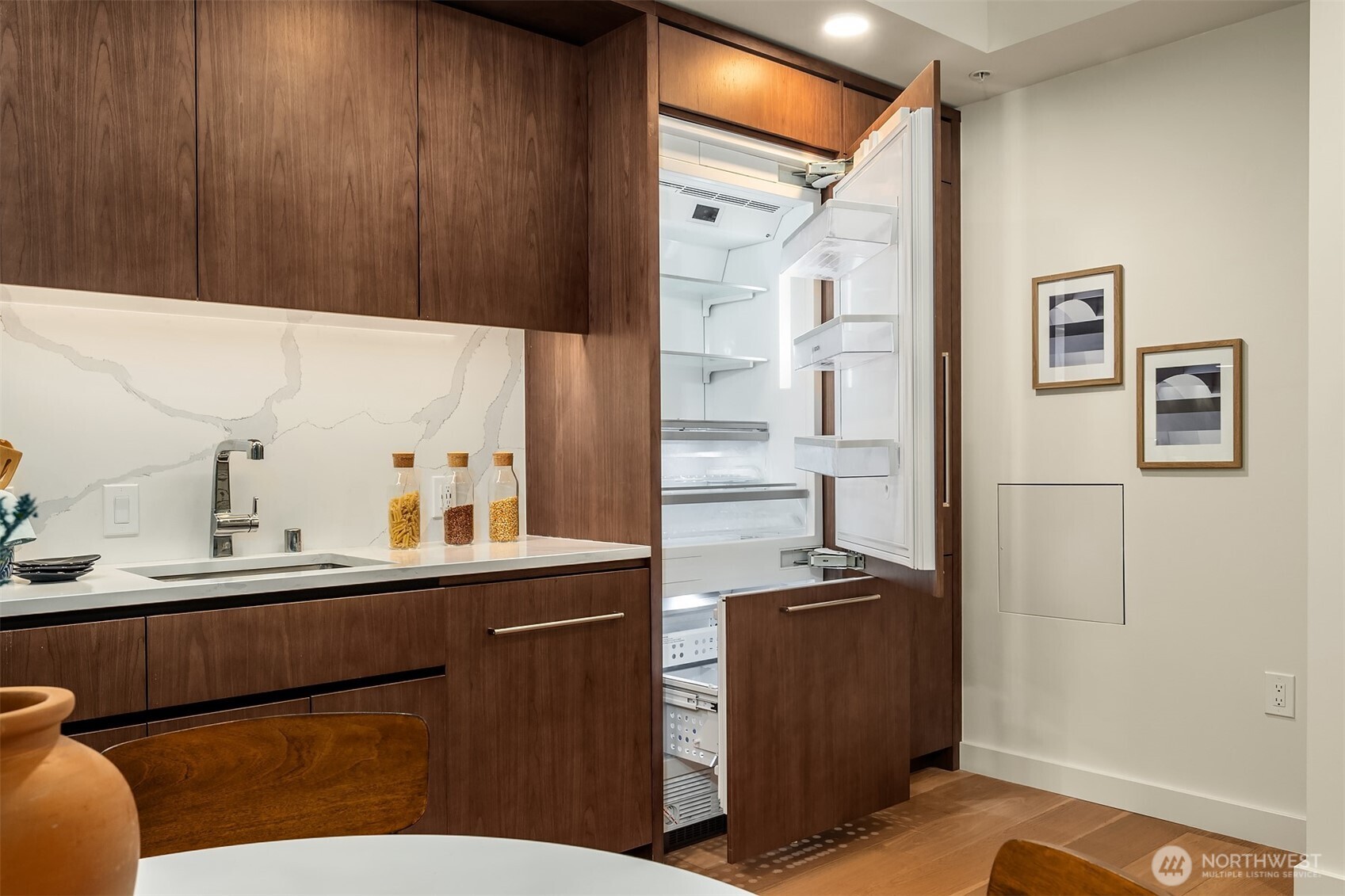 121 Stewart Street, Unit 1803 Seattle, WA 98101 - Photo 6 of 35 a kitchen with stainless steel appliances a sink and a refrigerator