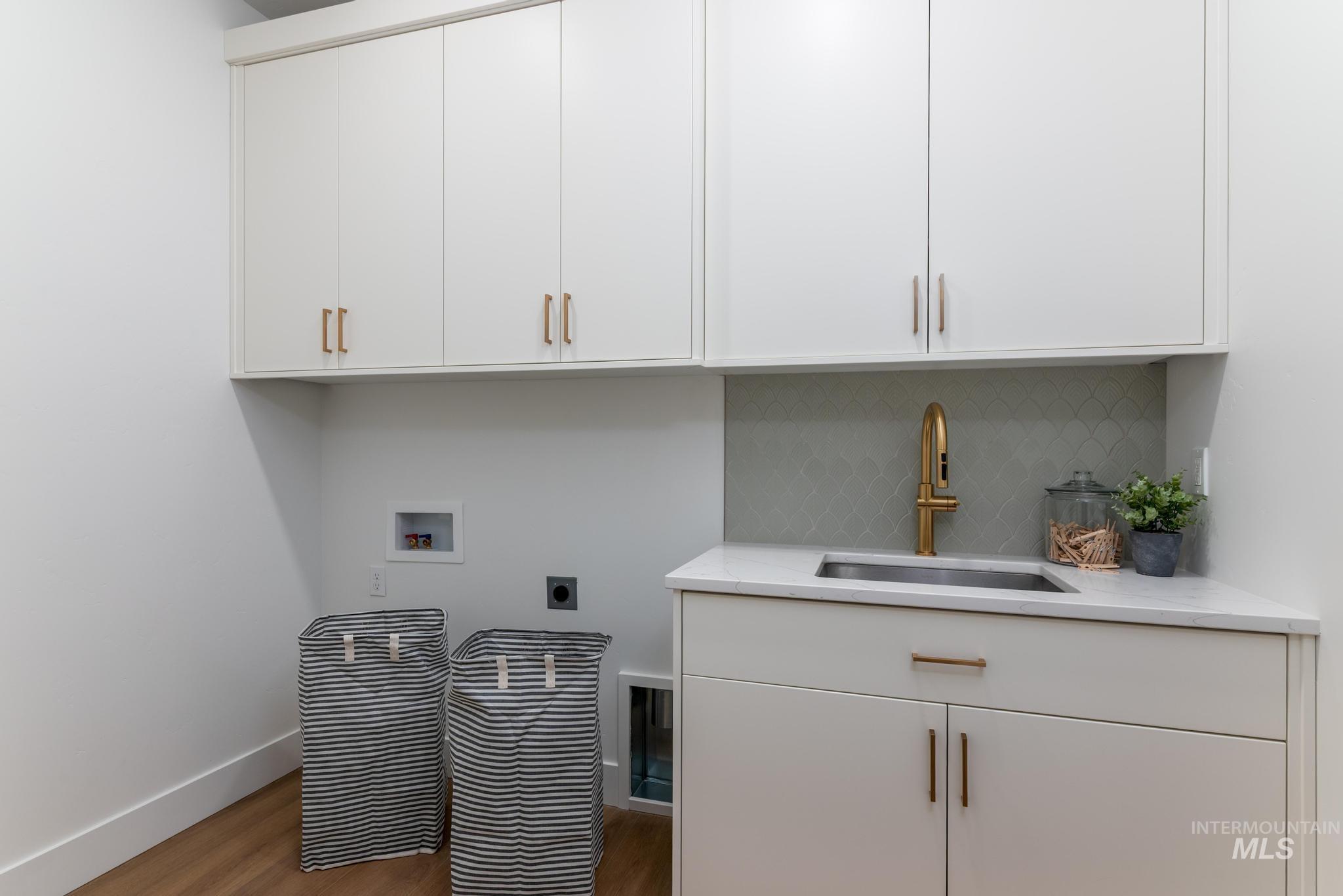 1925 Buckbrush Avenue Middleton, ID 83644 - Photo 10 of 20 Dedicated laundry area featuring abundant white cabinetry with brushed gold hardware