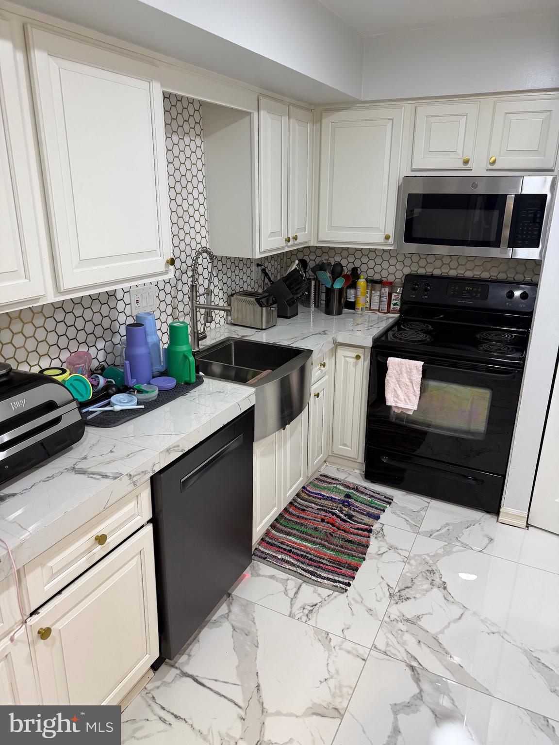 1801 Egg Harbor Road, Unit 712 Clementon, NJ 08021 - Photo 31 of 35 a kitchen with a sink stove and microwave