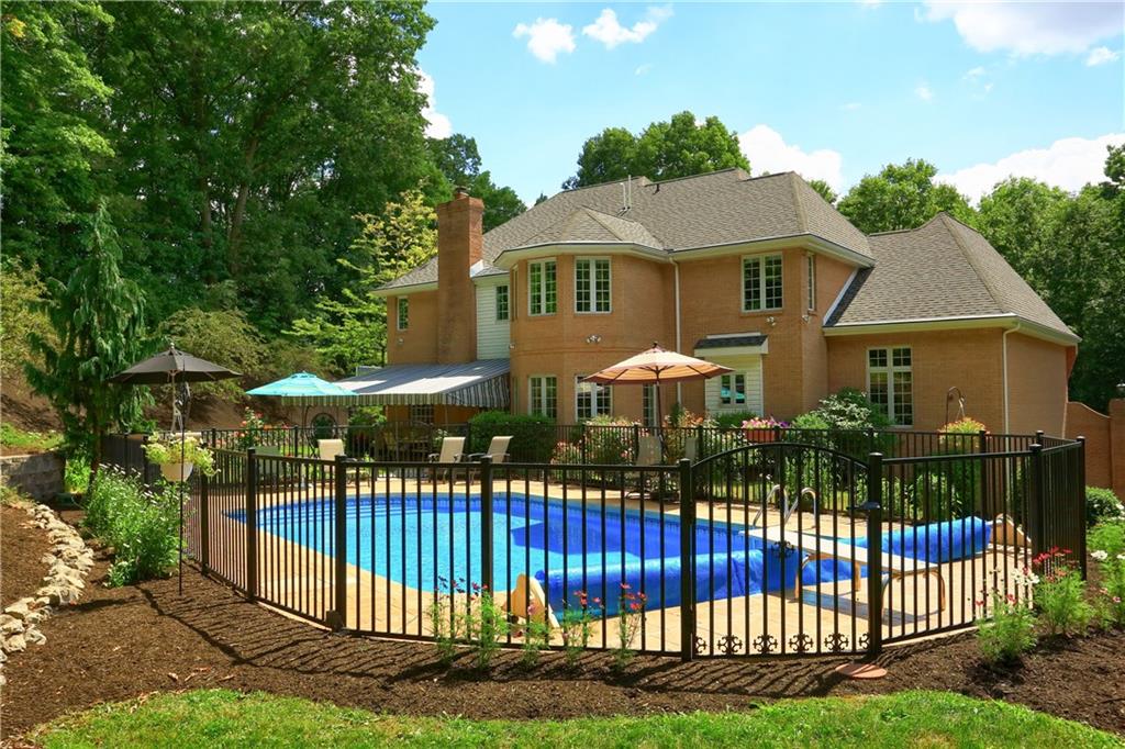 337 Parker Road Sarver, PA 16055 - Photo 2 of 25 View of the rear of the home and the swimming pool. The heated pool comes with all the equipment including a winter cover. Te pool deck is stamped concrete.