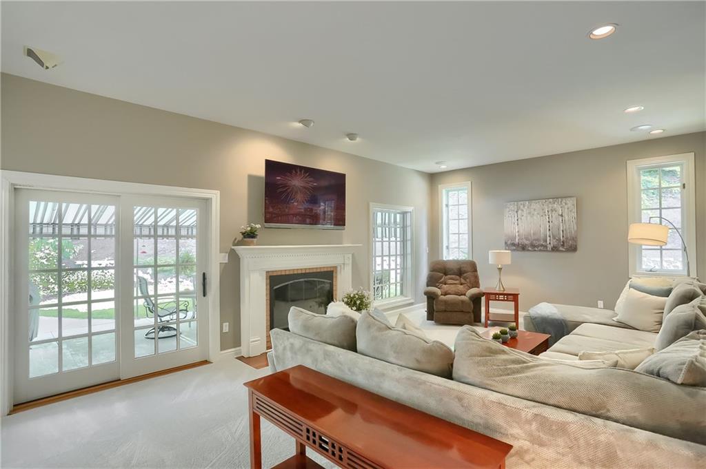 337 Parker Road Sarver, PA 16055 - Photo 11 of 25 Main floor family room with access to the back covered patio. The fireplace is a gas fireplace which could also be used as a log burning fireplace if desired.