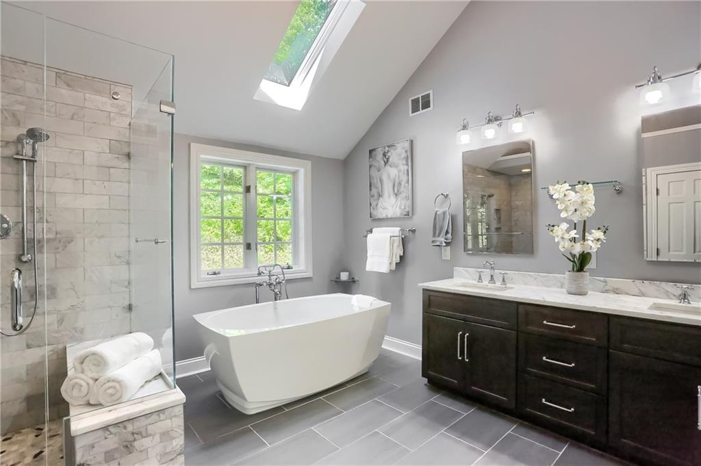 337 Parker Road Sarver, PA 16055 - Photo 16 of 25 Fabulously updated Master Bathroom with vaulted ceiling with skylight. It features huge soaking tub, double vanity sinks and a spacious glass and marble walk in shower.