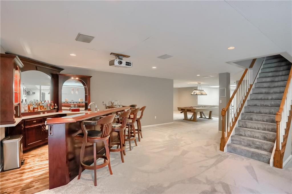 337 Parker Road Sarver, PA 16055 - Photo 23 of 25 Huge basement game room with a wet bar, fully equipped with wine fridge,mini fridge, and kegerator. Projection TV equipment including screen. Pool table included.