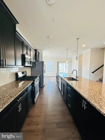 a large kitchen with stainless steel appliances kitchen island granite countertop a large counter top