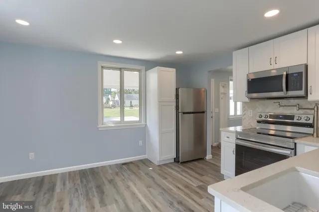 a kitchen with stainless steel appliances a refrigerator stove and microwave