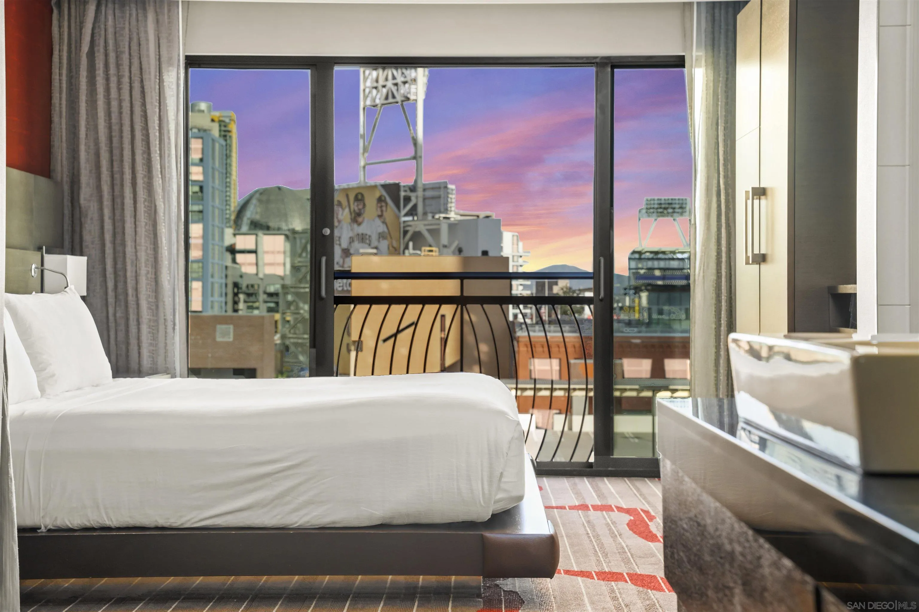 a bedroom with a large bed and a large window