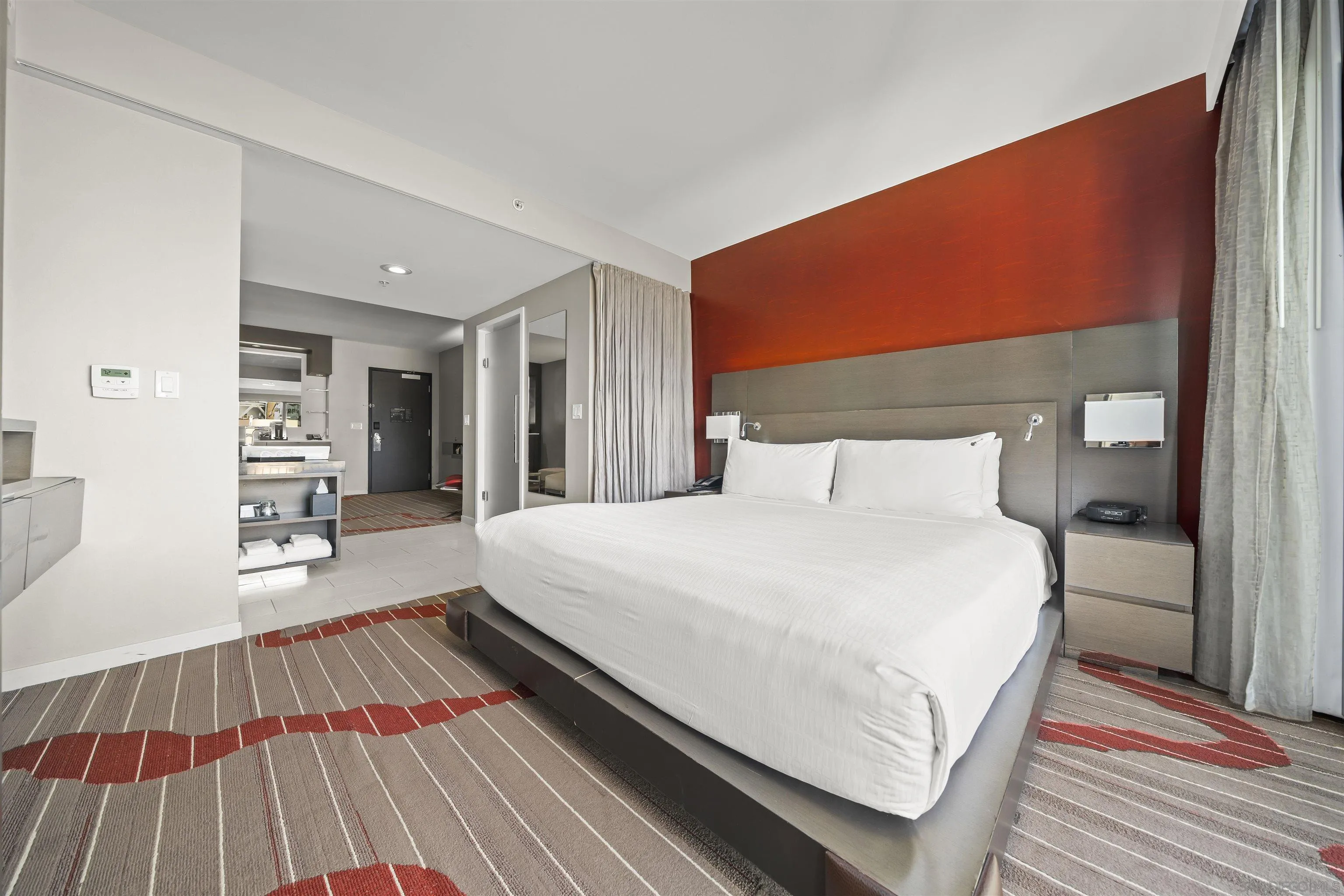 207 Fifth Avenue, Unit 940 San Diego, CA 92101 - Photo 11 of 31 a bedroom with a bed and wooden floor