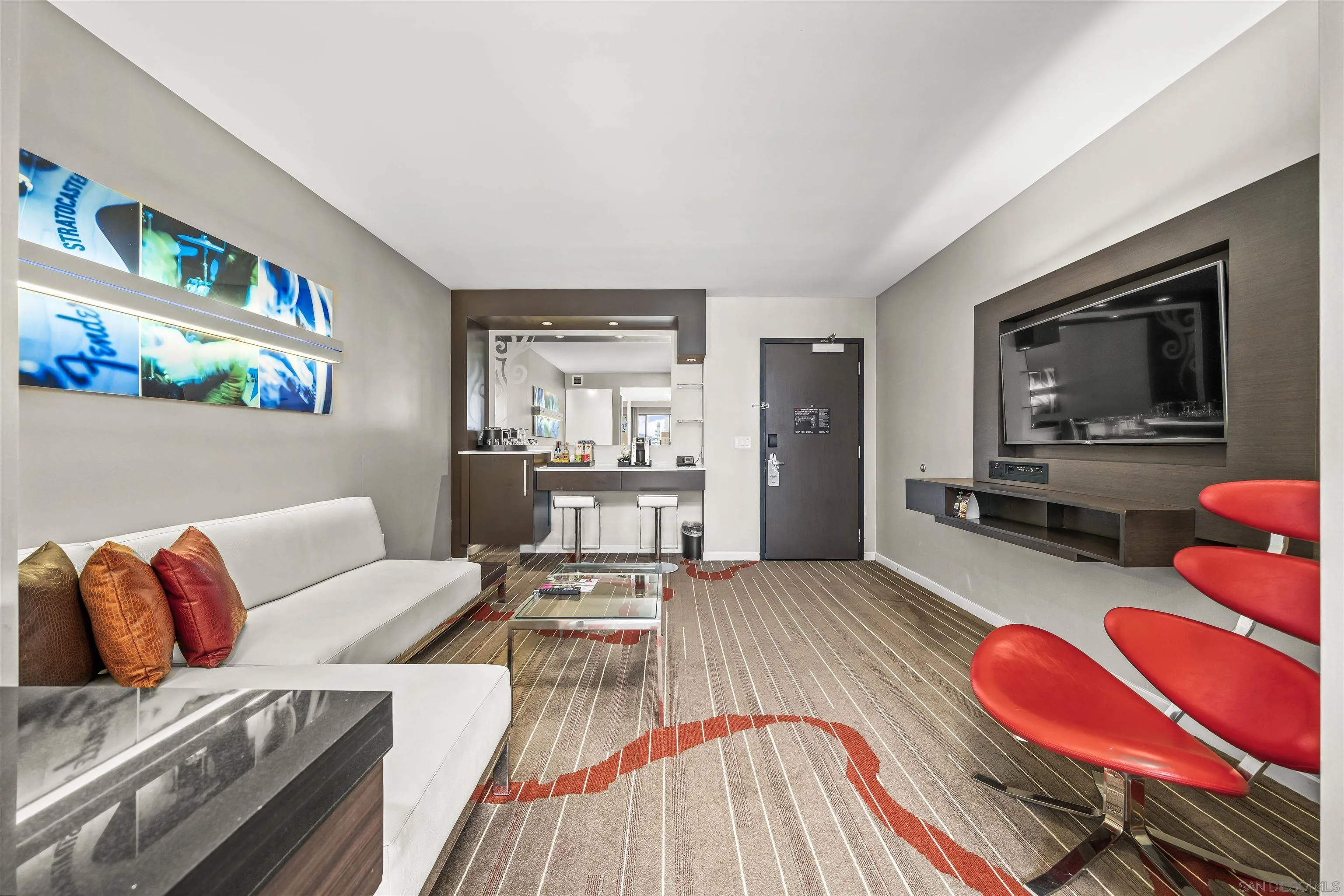 207 Fifth Avenue, Unit 940 San Diego, CA 92101 - Photo 2 of 31 a living room with furniture and a flat screen tv