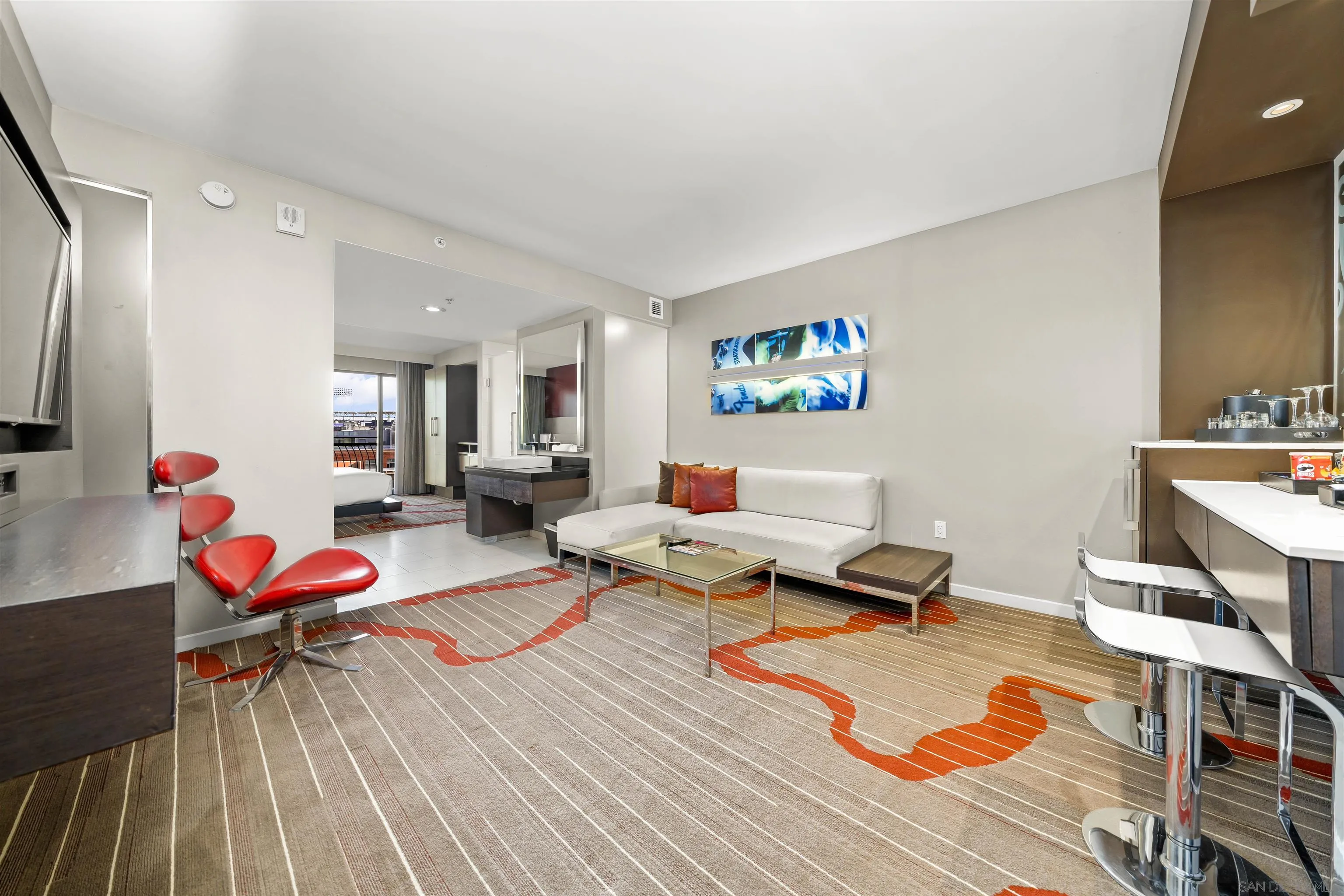 207 Fifth Avenue, Unit 940 San Diego, CA 92101 - Photo 4 of 31 a living room with furniture a rug and white walls