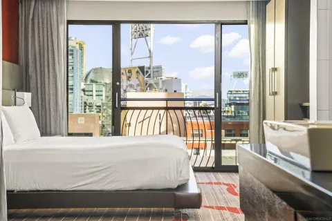 a bedroom with a large bed and a large window