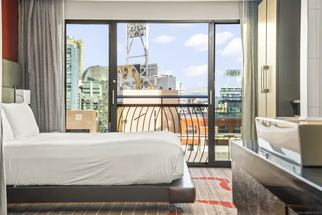 a bedroom with a large bed and a large window