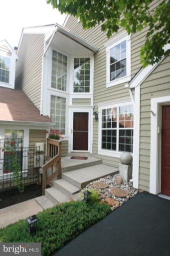 1506 Deer Point Way Reston, VA 20194 - Photo 13 of 30 a front view of a house with a yard and garage