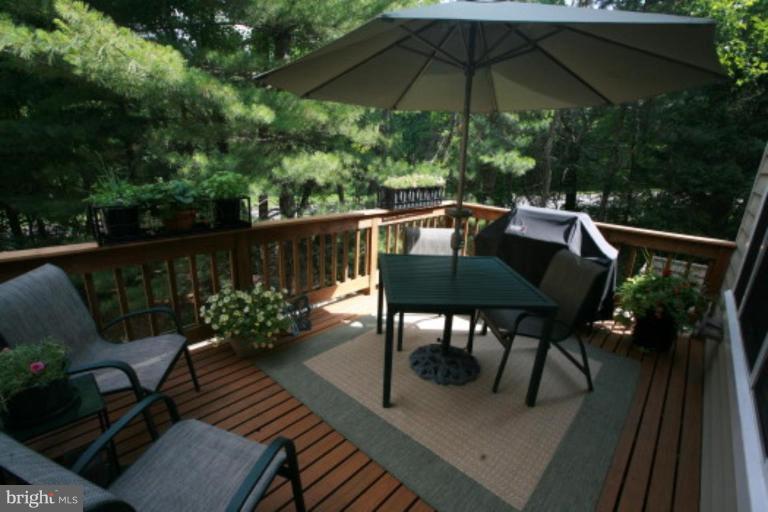 1506 Deer Point Way Reston, VA 20194 - Photo 14 of 30 a view of balcony with furniture and umbrella