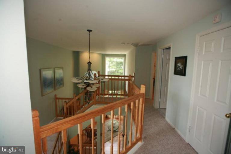 1506 Deer Point Way Reston, VA 20194 - Photo 17 of 30 a view of a hallway with windows