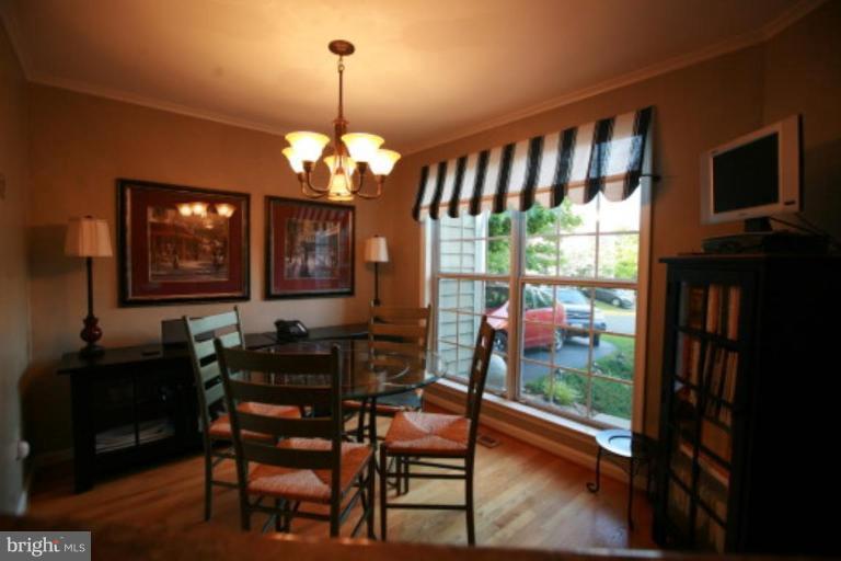 1506 Deer Point Way Reston, VA 20194 - Photo 3 of 30 a view of a dining room with furniture window and wooden floor