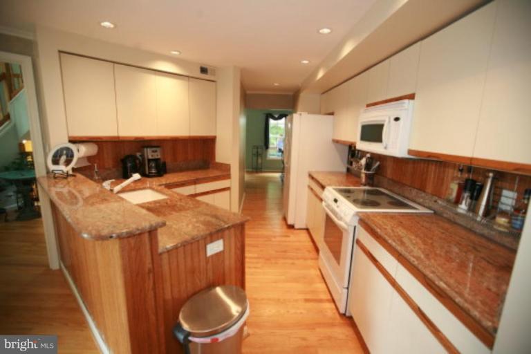 1506 Deer Point Way Reston, VA 20194 - Photo 21 of 30 a open kitchen with stainless steel appliances granite countertop a sink and a refrigerator