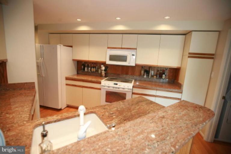 1506 Deer Point Way Reston, VA 20194 - Photo 22 of 30 a kitchen with stainless steel appliances granite countertop a refrigerator sink and stove