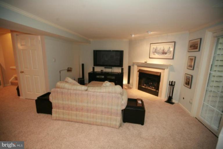 1506 Deer Point Way Reston, VA 20194 - Photo 28 of 30 a bedroom with a bed and a fireplace