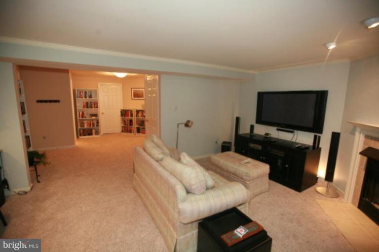 1506 Deer Point Way Reston, VA 20194 - Photo 29 of 30 a bedroom with a bed and a flat tv screen on wall
