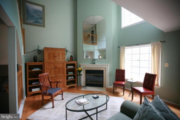 1506 Deer Point Way Reston, VA 20194 - Photo 4 of 30 a living room with furniture a fireplace and a large window